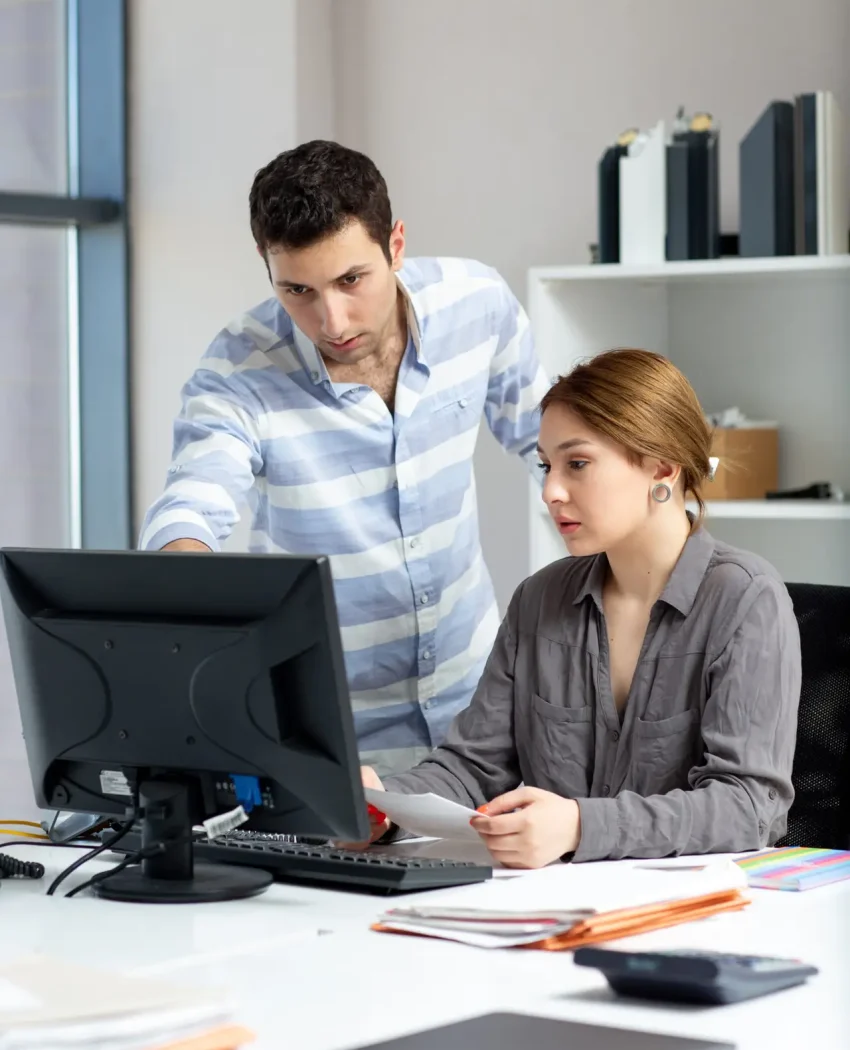 front-distanced-view-young-beautiful-lady-grey-shirt-talking-discussing-something-with-young-man-inside-office-daytime-building-job-activity